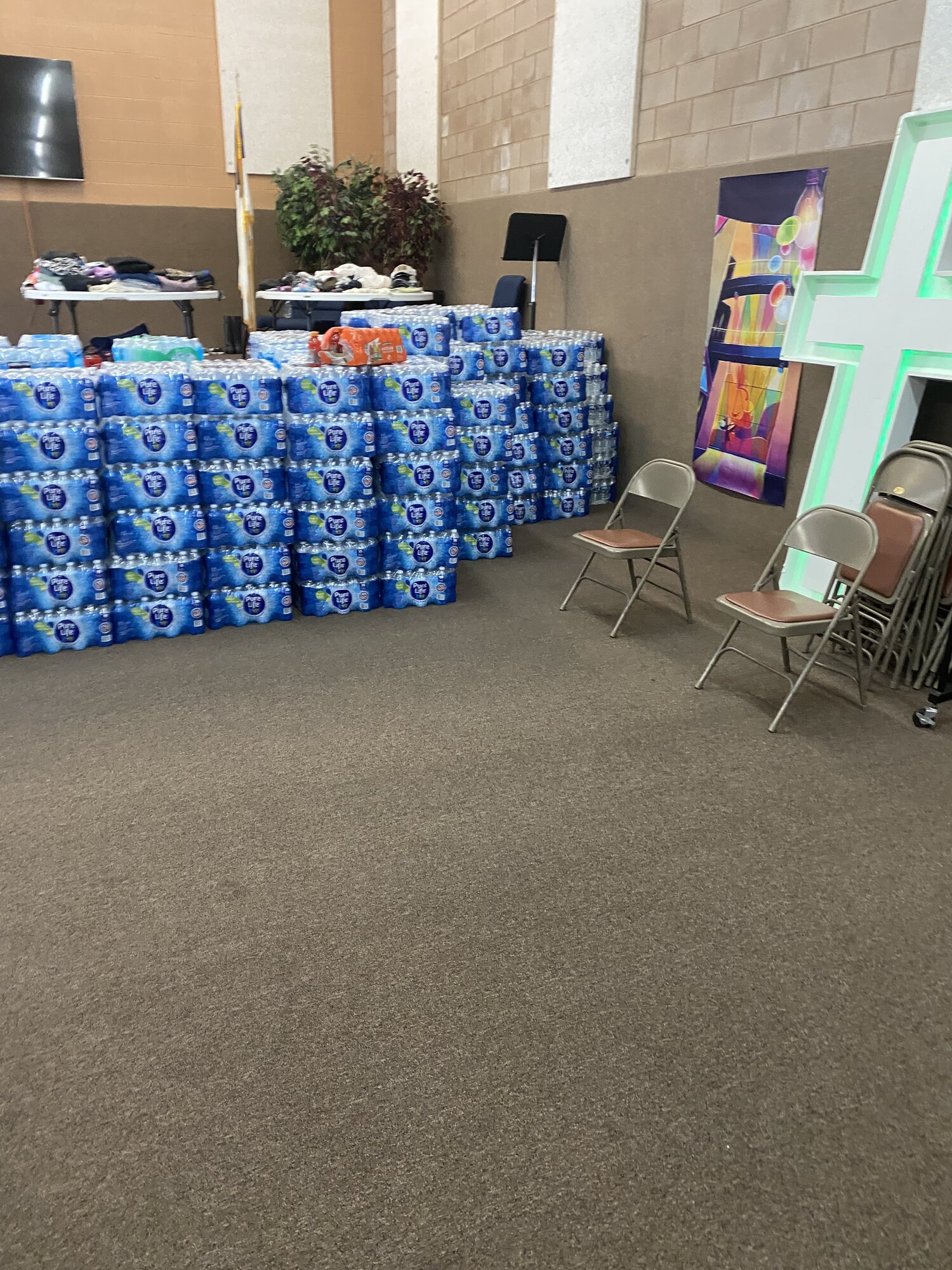 Pallets of donated bottled water stacked along the wall of the Valley Community Church hall